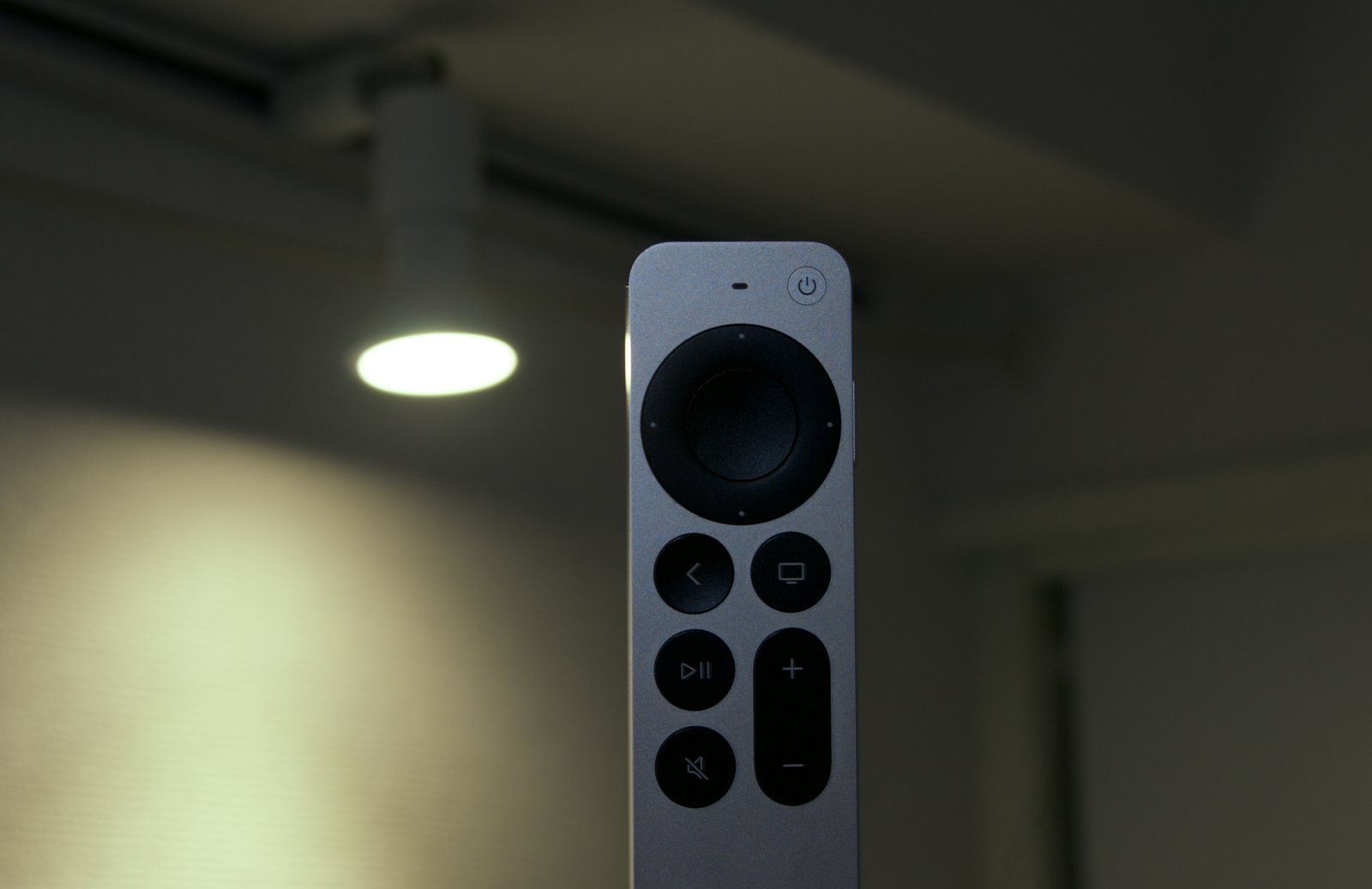Apple Siri Remote (A2854, 3rd gen) under a ceiling spotlight controlled by this project