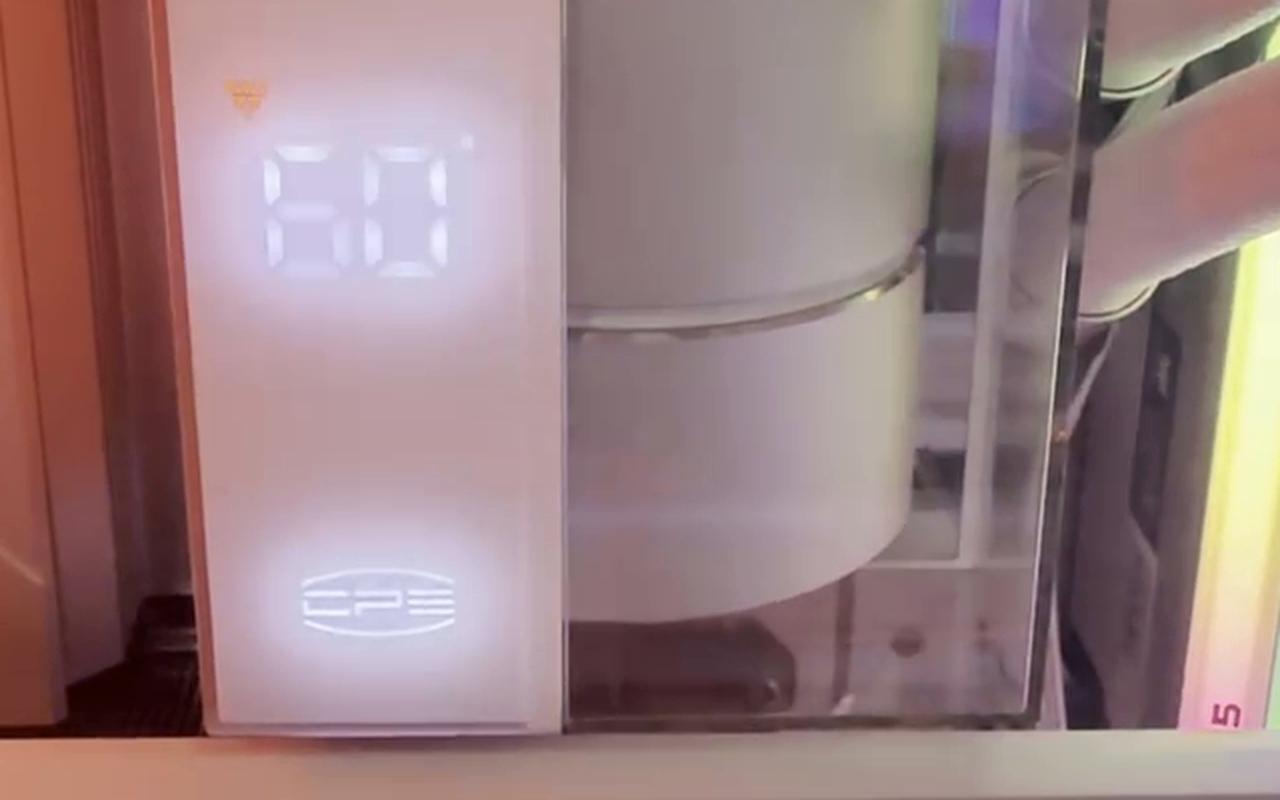 The CPS DS360 WH pump head reading 60 on its seven-segment display, photographed inside a running system